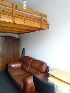 Bedroom - bed above seating